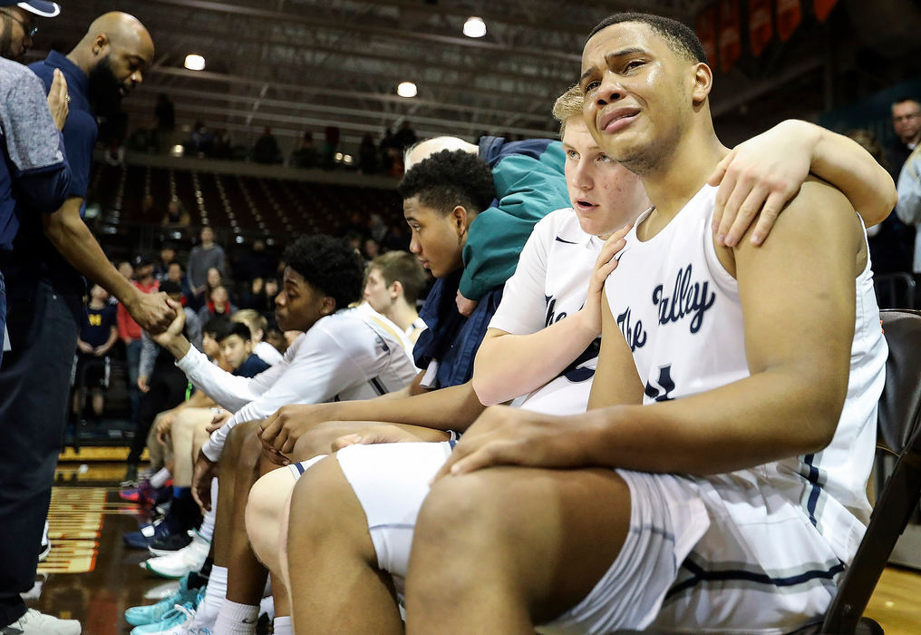 Sports Feature - 3rd placeMaumee Valley's Parker Chatman (right) is consoled by teammate Newt Ziegler after losing to Crestview 49-66 during the Division IV high school regional final at the Stroh Center in Bowling Green.(Rebecca Benson / The Blade)